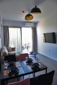 a living room with a table and a couch at The ViewPoint VP2 - Το διαμάντι της θέας in Mytilene