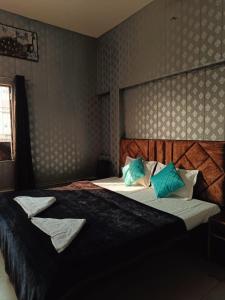 a bedroom with two beds with blue and white pillows at The Mystery Hostel in Varanasi