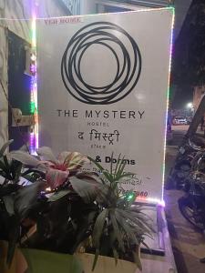 a sign for the mystery hotel and first floor delium at The Mystery Hostel in Varanasi