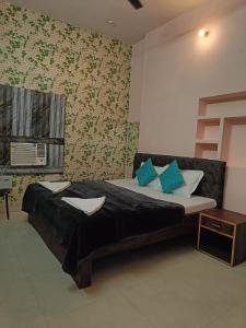 a bedroom with a bed with blue pillows at The Mystery Hostel in Varanasi