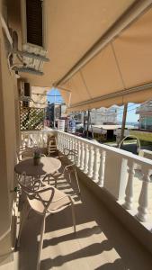 a balcony with tables and chairs on a ship at Sweet Nest in Paralia Katerinis