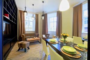 a living room with a table and a dining room at DeLuxe Apartment in Prague