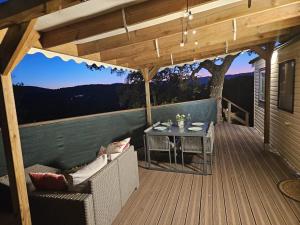 a patio with a table and chairs on a deck at St Tropez Surprise in Gassin