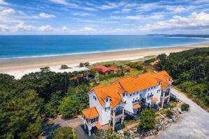 an aerial view of a house with an orange roof at Taean Red Balloon Pension in Taean
