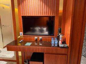 a hotel room with a desk with a flat screen tv at كلاديوم in Medina +17 photos