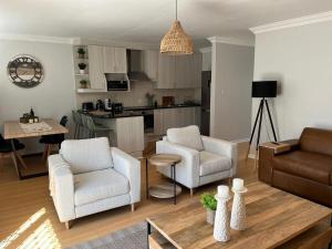 a living room with two chairs and a couch at The Little Cove in Strand
