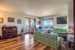 a living room with two couches and a table at GOCCE VILLAS - Sunshine Villa in Massa Lubrense