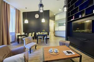 a living room with a table and a dining room at DeLuxe Apartment in Prague
