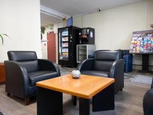 a waiting room with chairs and a coffee table at Hotel Bentley in Brussels