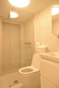 a bathroom with a toilet and a glass shower at Blossoming Hidden Nest with Garden in Ljubljana