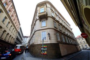 a building on the side of a street with a bus at DeLuxe Apartment in Prague