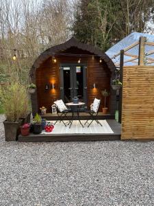 a small cabin with a table and chairs in it at Go Glamping at Inverness & Loch Ness in Inverness +23 photos