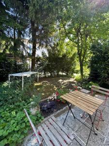 a picnic table and a bench in a garden at Blossoming Hidden Nest with Garden in Ljubljana