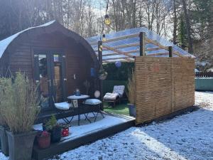 a small wooden shed with a table and a bench at Go Glamping at Inverness & Loch Ness in Inverness