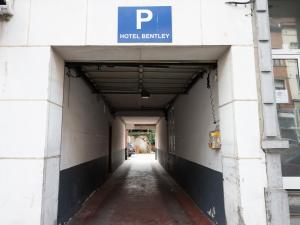 a hallway of a building with a parking sign on it at Hotel Bentley in Brussels +16 photos