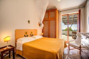 a bedroom with a bed and a large window at GOCCE VILLAS - Sunshine Villa in Massa Lubrense +71 photos