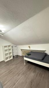 an empty room with a bed and shelves in it at Monteurswohnung Mesum in Rheine