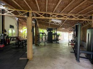 an empty room with a gym with chairs and tables at Villa Kiri in Ko Phangan