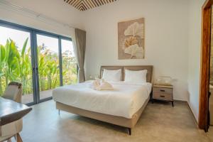 a bedroom with a bed and a large window at Villa Kiri in Ko Phangan +22 photos