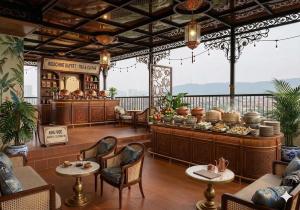 a restaurant with tables and chairs in a room at Bảo Long Lào Cai Hotel in Lao Cai