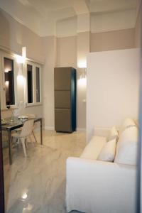a living room with a white couch and a table at Luxury Suite ATHENA - MINERVA in Reggio di Calabria +16 photos
