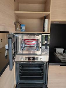 a kitchen with an oven in a small room at Luxury Cottage Sauna&Pool at CapDAgde in Agde