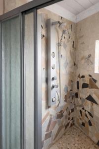 a shower in a bathroom with a stone wall at Nairobi Guesthouse in Orkney +6 photos
