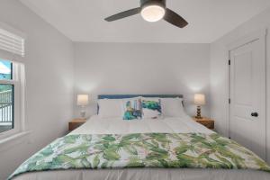 a bedroom with a bed with a ceiling fan at Spacious 3BR Beach Retreat Sleeps 10 Family Ready in Port Saint Joe