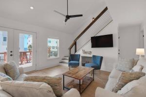 a living room with a couch and chairs and a tv at Spacious 3BR Beach Retreat Sleeps 10 Family Ready in Port Saint Joe