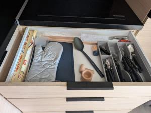 a drawer filled with utensils in a box at Luxury Cottage Sauna&Pool at CapDAgde in Agde