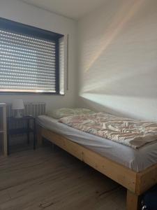 a bed sitting in a room with a window at Monteurwohnung und Ferienwohnung Philippsburg in Philippsburg