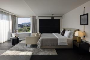 a bedroom with a large bed and a large window at Arcadia Small courtyard in Dali Shuanglang +66 photos