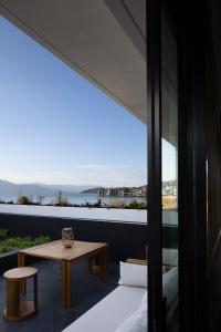 a balcony with a table and a view of the ocean at Arcadia Small courtyard in Dali Shuanglang