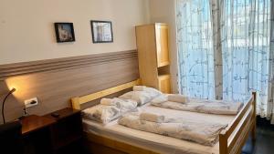 two twin beds in a room with a window at Hostel Moving in Zagreb