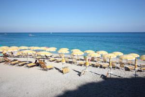 a bunch of chairs and umbrellas on a beach at Casa Baia Verde sul Mare Baia Verde Beach Apartment in Castel Volturno