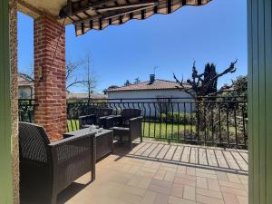 a patio with chairs and tables and a fence at Les trois Pitchounes- Wifi- Piscine- Calme in Albi