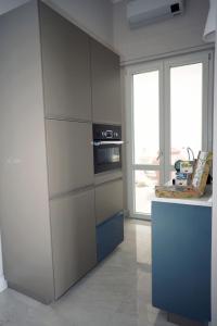 a kitchen with a counter and a stove top oven at Luxury Suite ATHENA - MINERVA in Reggio di Calabria
