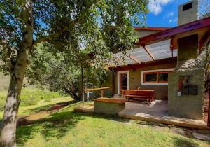 a house with a picnic table and a bench in the yard at Pat Busch Mountain Reserve in Robertson