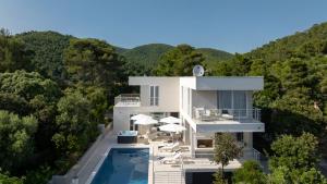 an aerial view of a white house with a swimming pool at VILLA MON AMOUR by Villas Guide in Blato