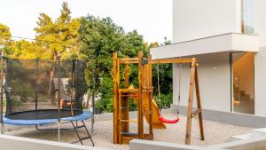 a playground with a slide and a trampoline at VILLA MON AMOUR by Villas Guide in Blato