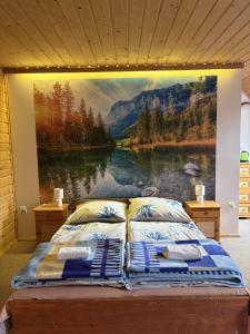 a bedroom with a large painting of a lake at ANTON Tenczyn in Tenczyn +18 photos