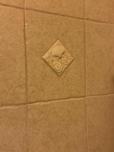 a tile floor with a vent in a bathroom at Hotel Žućo in Biograd na Moru