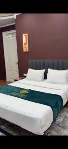 a large bed with a blue blanket on it at Boston Grand hotel in Osh +1 photo
