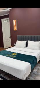 a large bed with a blue blanket on top of it at Boston Grand hotel in Osh