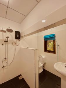 a bathroom with a shower and a toilet and a sink at Sky Vista by Jonathan's way in Negombo