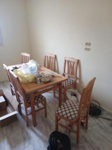 a dining room table with four chairs and a table and chairsktop at Share Apartment but Private Room in Madinat Al Ashir min Ramadan