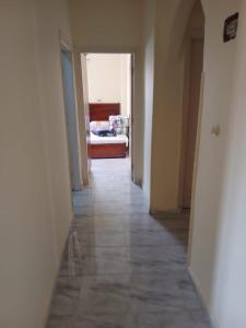 a hallway with a bedroom and a bed in a room at Share Apartment but Private Room in Madinat Al Ashir min Ramadan