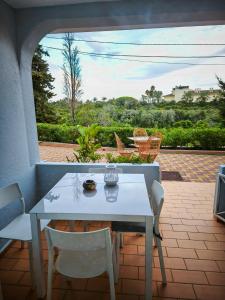 a white table and chairs on a patio at Villa Welwitshia in Carvoeiro