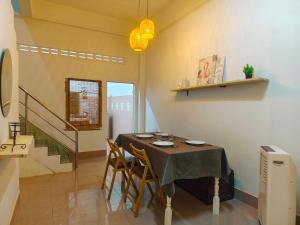 a dining room with a table and chairs and a staircase at whole house for 5 guests 3 beds in Hat Yai