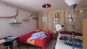 a bedroom with two beds and a desk and a lamp at AïnaPat in Carmaux